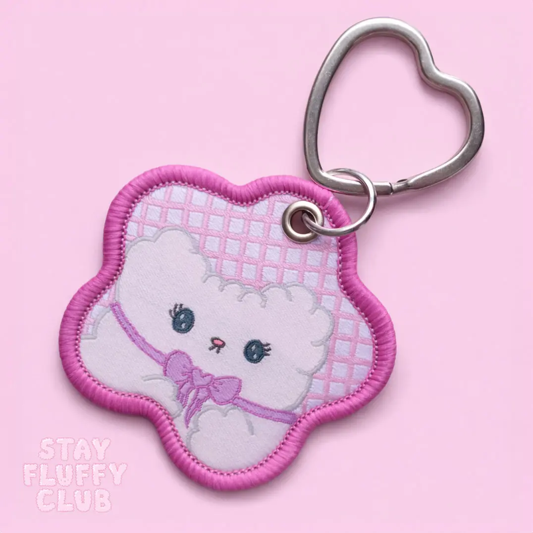 Embroidered Clover character keychain with a heart-shaped clasp
