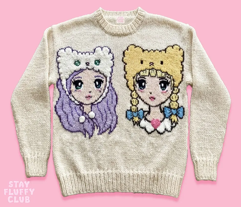 Cream knit sweater featuring Luna and Mina in fluffy character hats