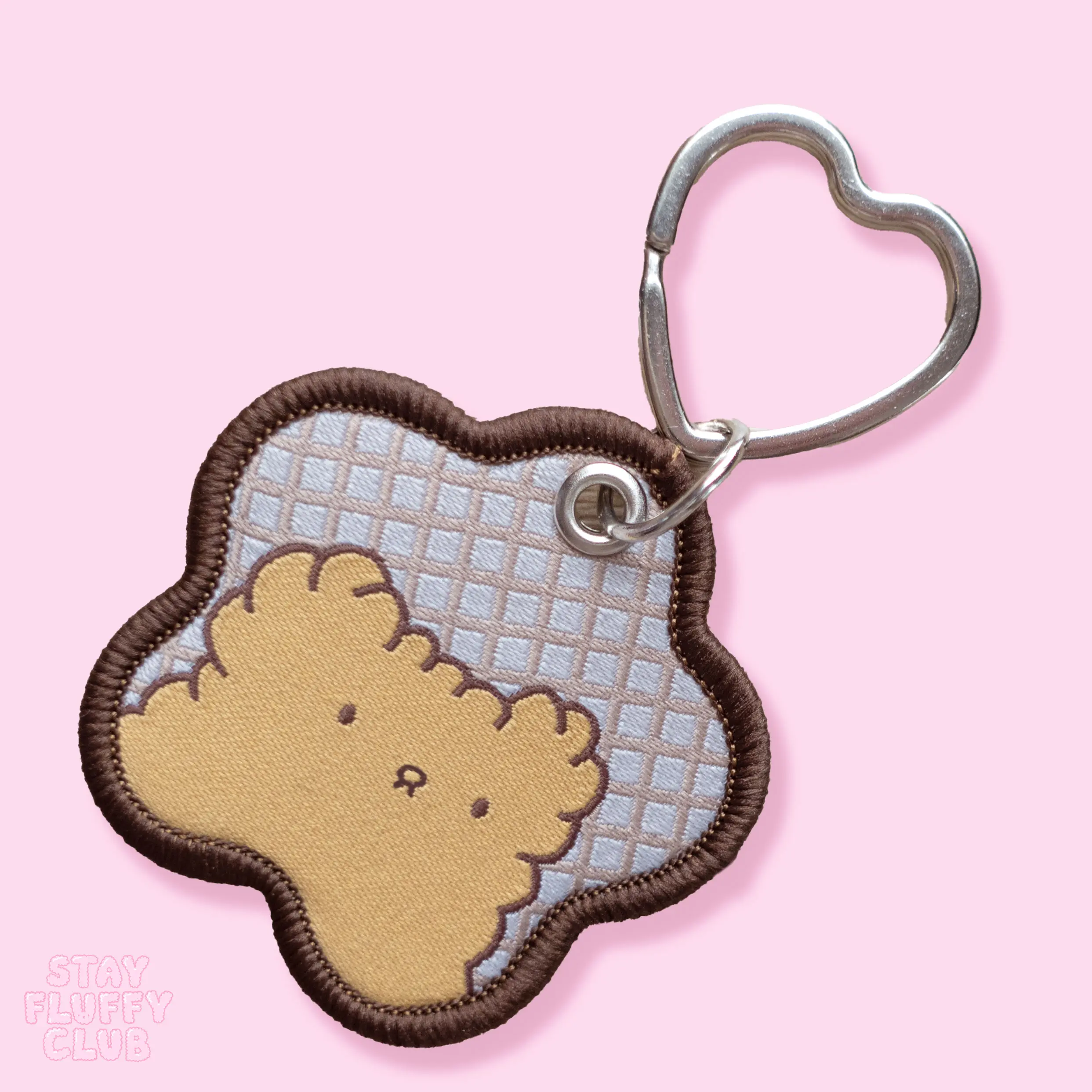 Embroidered Osito character keychain with a heart-shaped clasp