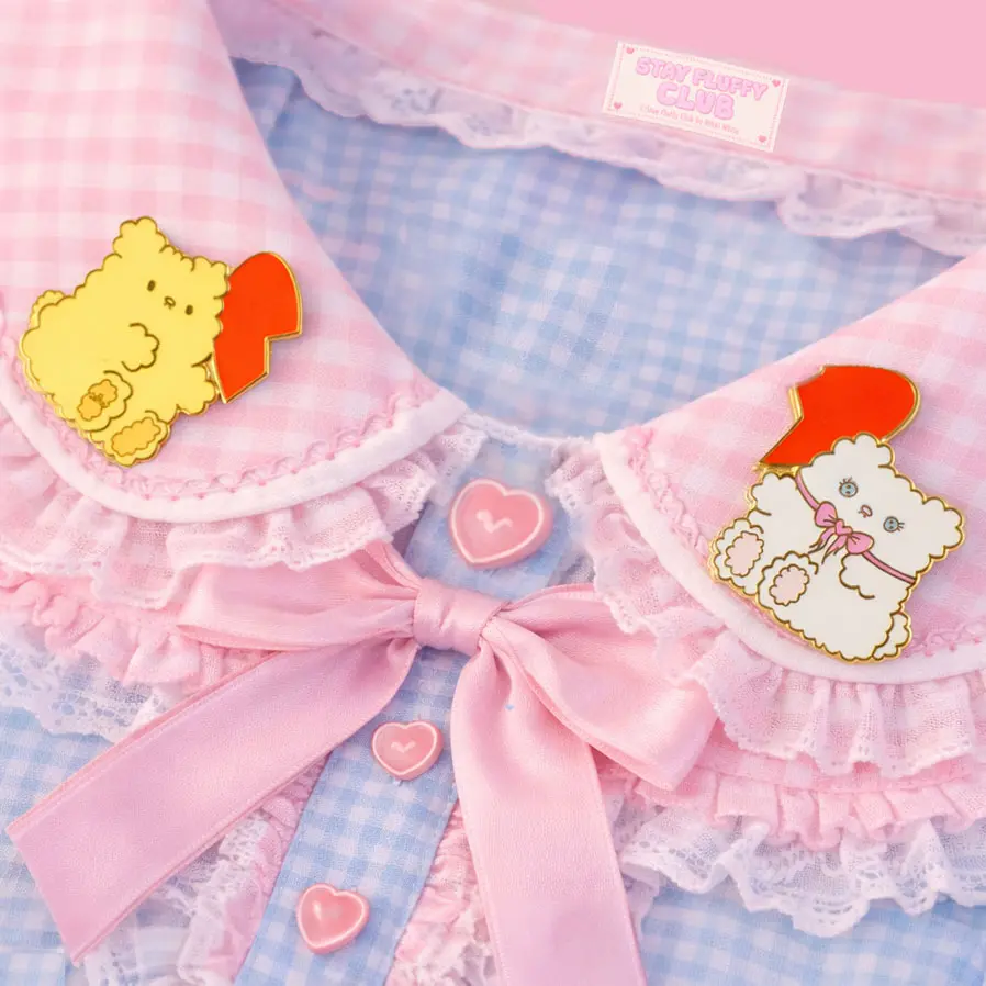 Osito and Clover best-friend pins on a pink gingham lace collar