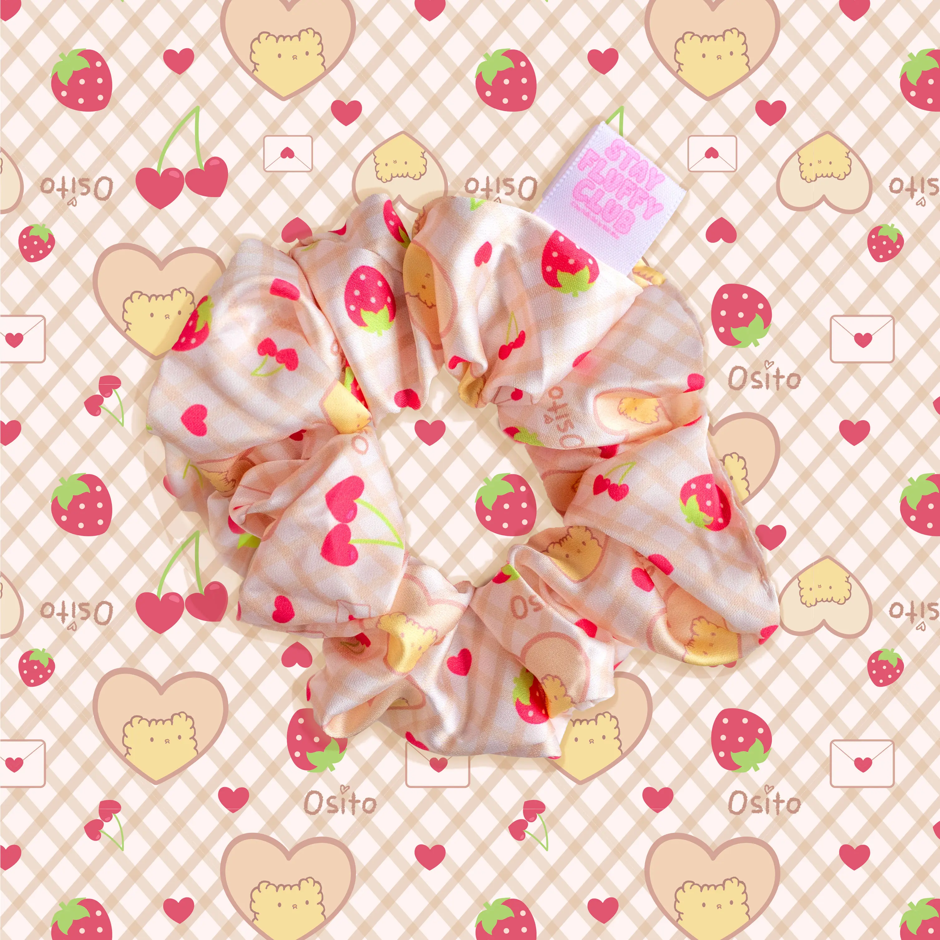 Osito fruit-print scrunchie on a beige gingham background